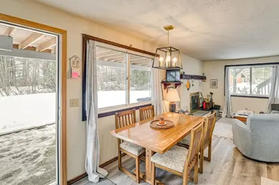 a kitchen and dining room with a table and chairs at 3 Mi to Windham Mountain Pet-Friendly Apt with Yard in Hensonville