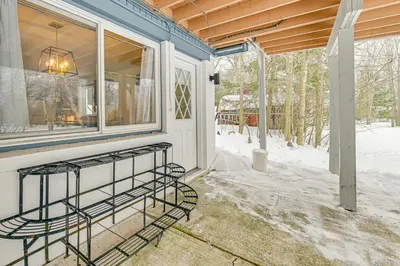 a screened in porch with a window and snow on the ground at 3 Mi to Windham Mountain Pet-Friendly Apt with Yard in Hensonville