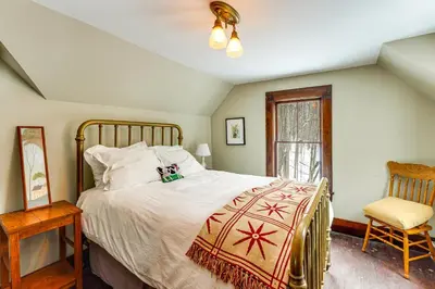 a bedroom with a large bed and a chair at 2 Mi to Belleayre Mtn! Extended Base in Pine Hill in Pine Hill