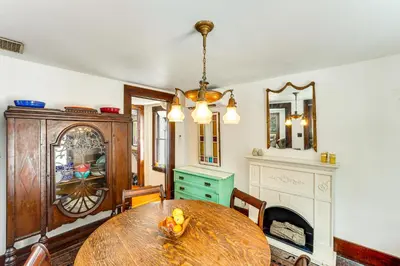 a dining room with a wooden table and a fireplace at 2 Mi to Belleayre Mtn! Extended Base in Pine Hill in Pine Hill