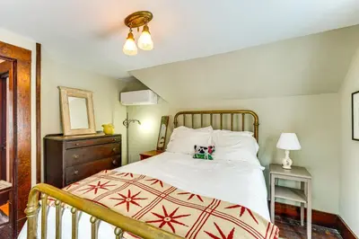 a bedroom with a bed with a wooden headboard at 2 Mi to Belleayre Mtn! Extended Base in Pine Hill in Pine Hill