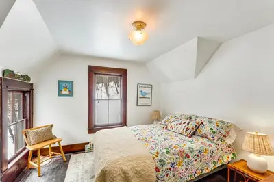 a bedroom with a bed and a chair and a window at 2 Mi to Belleayre Mtn! Extended Base in Pine Hill in Pine Hill