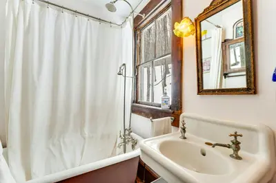 a bathroom with a sink and a tub and a mirror at 2 Mi to Belleayre Mtn! Extended Base in Pine Hill in Pine Hill