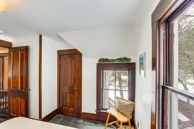 a room with a bed and a window and a chair at 2 Mi to Belleayre Mtn! Extended Base in Pine Hill in Pine Hill