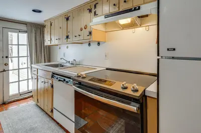a kitchen with a sink and a refrigerator at Historic 1820s Homestead on Battenkill River! in Arlington