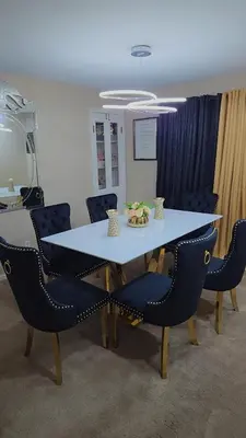 a table and chairs in a room with a table and chairs at cozy 5bd single -family home in Longmeadow in Longmeadow