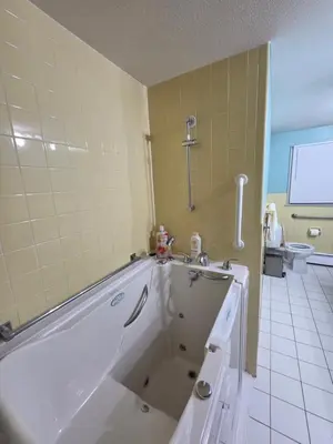 a bathroom with a tub and a toilet at cozy 5bd single -family home in Longmeadow in Longmeadow