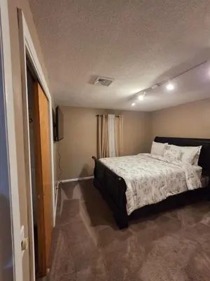 a bedroom with a bed with white sheets and pillows at cozy 5bd single -family home in Longmeadow in Longmeadow