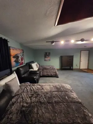 a living room with a couch and a bed and a room with a couch at cozy 5bd single -family home in Longmeadow in Longmeadow