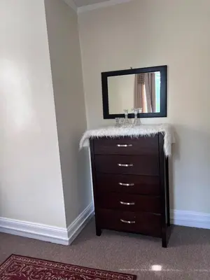 a bathroom with a dresser and a mirror at Eden's Cozy Oasis in Windsor