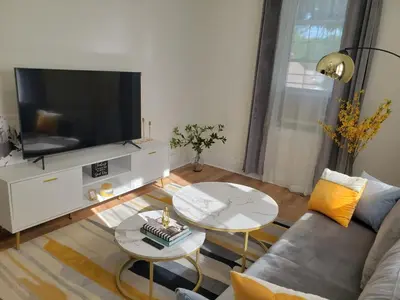a living room with a couch and a tv at NYC Escape Easy Transit Easy Parking Quiet Area in Teaneck