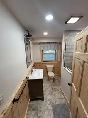a bathroom with a toilet and a sink at Cattail Cabin in Waterville