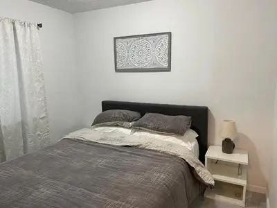 a bedroom with a bed and a picture on the wall at Woodside Haven - Game Room - Central AC - Pet Friendly in Tobyhanna