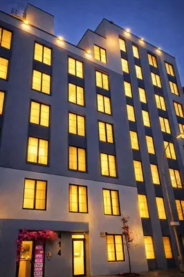 a large building with many windows at night at Rose Hotel Near Yankee Stadium in Bronx