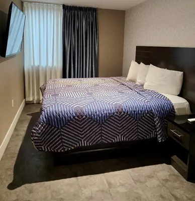 a hotel room with a bed and a window at Rose Hotel Near Yankee Stadium in Bronx