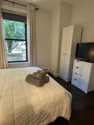 a bedroom with a bed with towels on it at Comfortable - Exc Location Apt 2BD 1BA Downtown JC 12 min to NYC in Jersey City