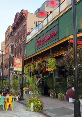 a restaurant on a city street with tables and chairs at Comfortable - Exc Location Apt 2BD 1BA Downtown JC 12 min to NYC in Jersey City