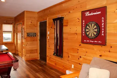 a room with a dart board on the wall at Wildberry Chalet in Stamford