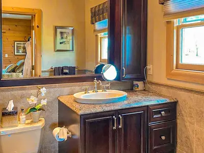 a bathroom with a sink and a mirror at Wildberry Chalet in Stamford