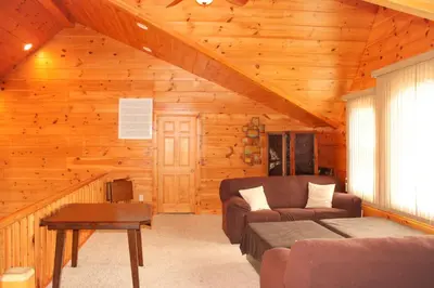 a living room with a couch and a table at Wildberry Chalet in Stamford