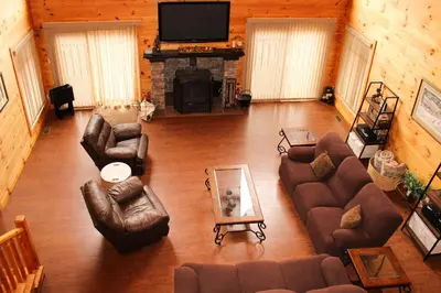 a living room with couches and a fireplace and a television at Wildberry Chalet in Stamford