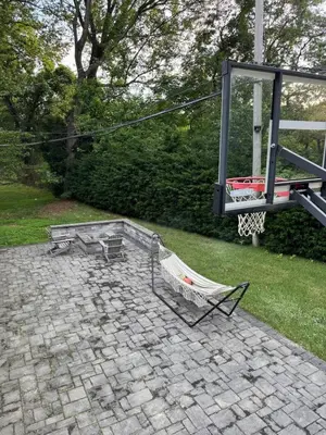 a patio with a bench and a basketball hoop at Curated Suite with Soaking Tub and Walk to Whole Foods in Jericho