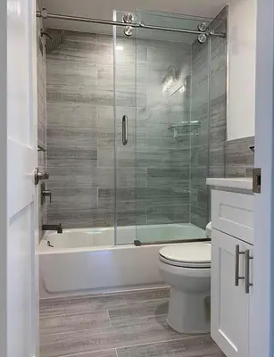 a bathroom with a toilet and a glass shower at Curated Suite with Soaking Tub and Walk to Whole Foods in Jericho
