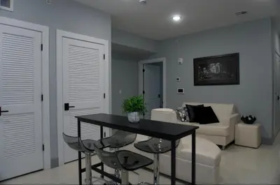 a living room with a table and a couch at Big Apple room 34 in West New York