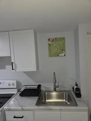 a kitchen with a sink and a sign that reads dream big at Private Executive Suite in Waterbury