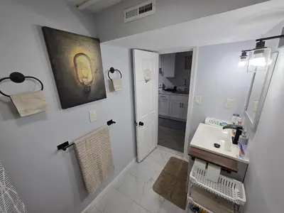 a white bathroom with a sink and a mirror at Private Executive Suite in Waterbury