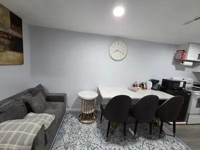 a living room with a couch and a table with chairs at Private Executive Suite in Waterbury