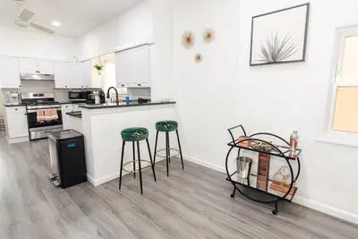 a kitchen with a counter and stools in a room at Luxury North Bergen 3 BR APT in North Bergen