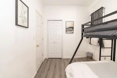 a bedroom with a bunk bed and a staircase at Luxury North Bergen 3 BR APT in North Bergen