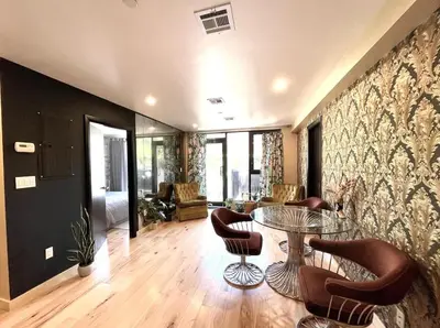 a living room with a glass table and chairs at Bright 2-Story Brooklyn Oasis w Patio & Fire Pit in Brooklyn