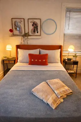 a bedroom with a bed with two towels on it at Superior Queen Bed & Fulton Bed in Mount Vernon