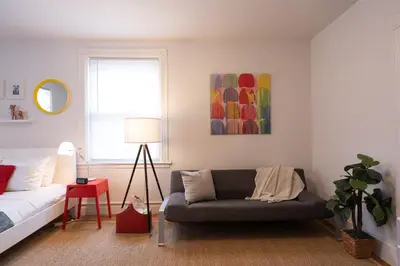 a living room with a couch and a bed at Superior Queen Bed & Fulton Bed in Mount Vernon