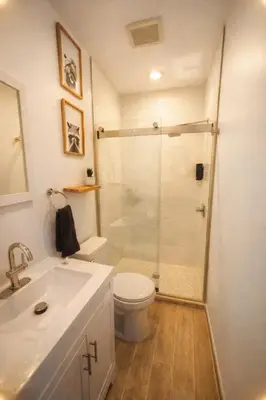 a bathroom with a shower and a toilet and a sink at Superior Queen Bed & Fulton Bed in Mount Vernon