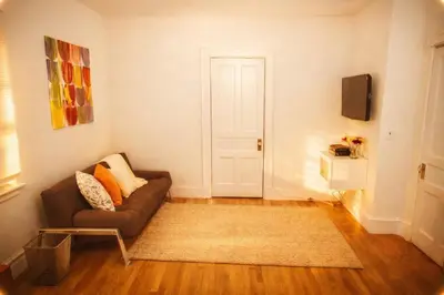 a living room with a couch and a door at Superior Queen Bed & Fulton Bed in Mount Vernon