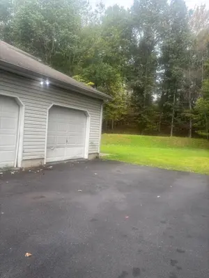 a garage with two garage doors in a driveway at Poconos home away from home in East Stroudsburg