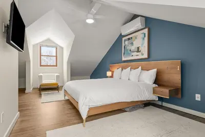 a bedroom with a bed and a blue wall at Cozy Creekside Retreat - Minutes to Delhi & Andes in De Lancey