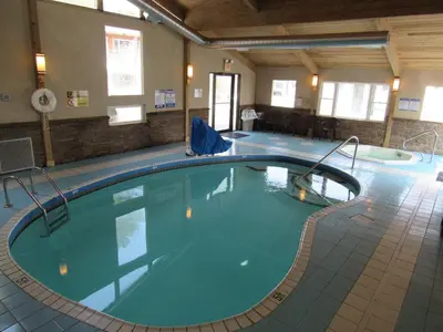 a large swimming pool in a hotel room at Lake 'N Pines Motel in Cooperstown