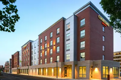 a large brick building on a city street at Courtyard by Marriott Edgewater NYC Area in Edgewater