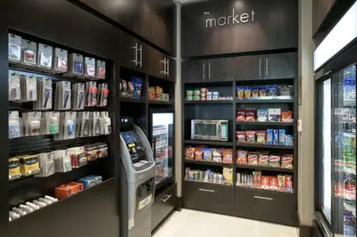 a grocery store aisle with a cash register and food at Courtyard by Marriott Edgewater NYC Area in Edgewater