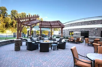a patio with chairs and tables and a pavilion at Staybridge Suites Albany Wolf Rd-Colonie Center by IHG in Albany