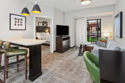 a hotel room with a bed and a living room at Staybridge Suites Albany Wolf Rd-Colonie Center by IHG in Albany
