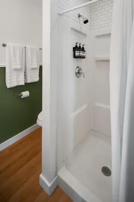 a bathroom with a shower with a glass door at Birches Motel in Saratoga Springs