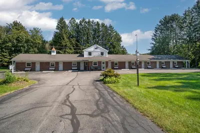 an empty road in front of a building at Birches Motel in Saratoga Springs
