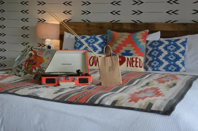 a bed with a laptop computer on top of it at Hotel Dylan in Woodstock