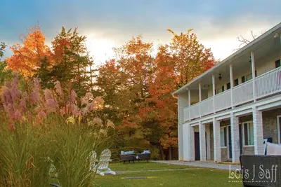 a building with a yard next to a building at Hotel Dylan in Woodstock