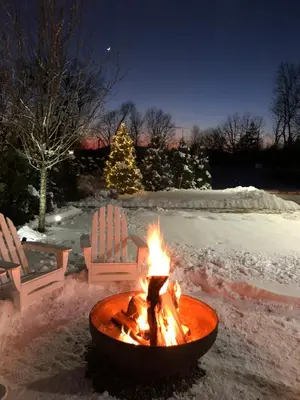 a fire pit with two chairs in the snow at Hotel Dylan in Woodstock